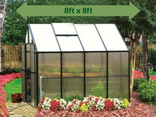 Riverstone Monticello Greenhouse 8x8 - Premium Package - side view - green arrow on top showing dimensions - in a garden