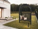 The Adelaide Dove Gray Arbor With Bench and Pillows in a garden