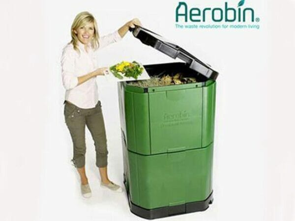 Aerobin 400 Insulated Composter - with a woman on the side pouring compost into the bin - gray background