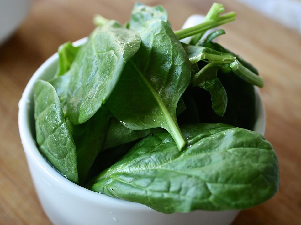 Spinach leaves in a white cup