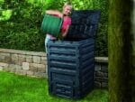 Eco Master 450 Compost Bin and a woman pouring compost into the bin.