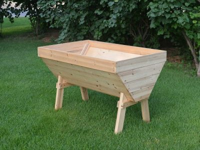 A V-Shaped Garden Table made from solid wood on a lawn