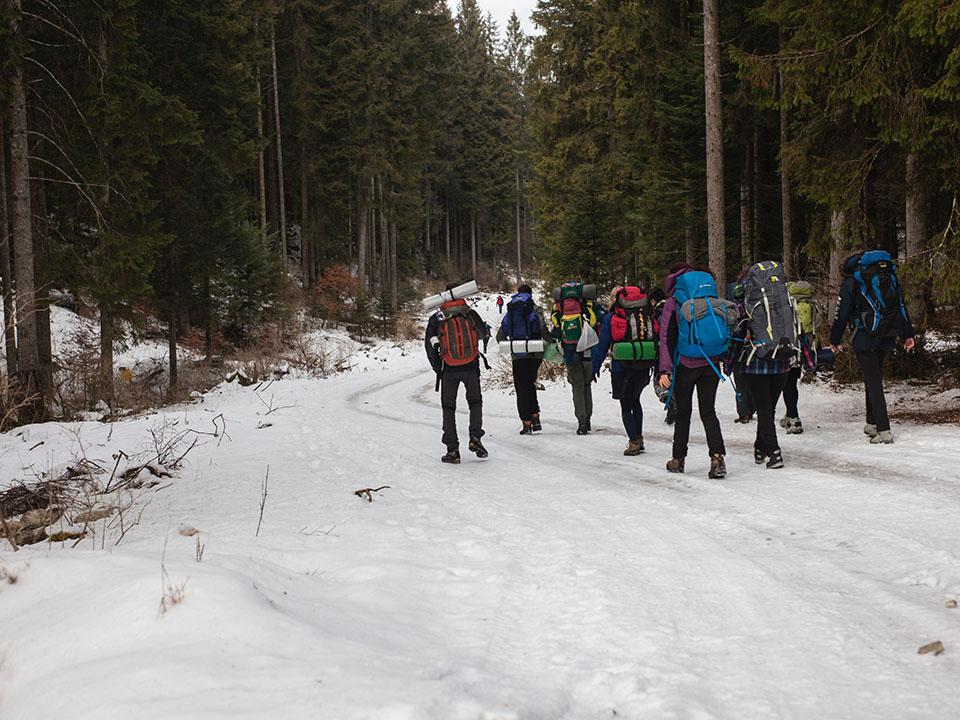 Hikers in winter with big backpacks