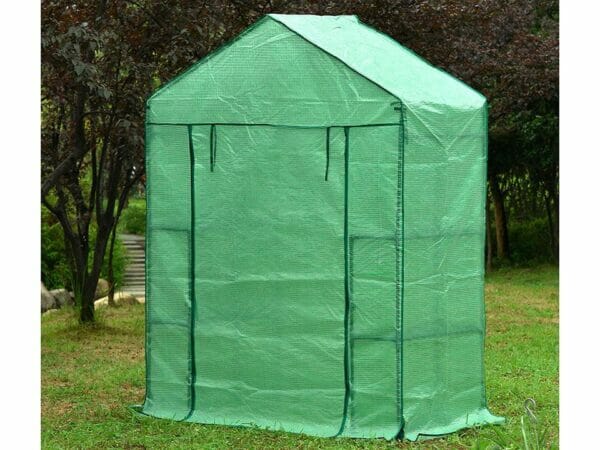Small green Genesis Portable Walk In Greenhouse with closed roll-up door in a garden