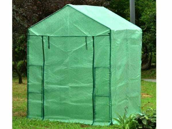 Large green Genesis Portable Walk In Greenhouse with closed roll-up door in a garden