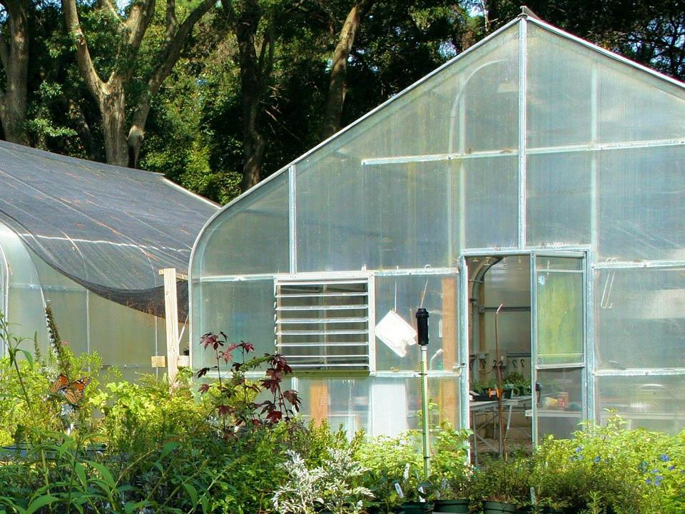 Front view of a greenhouse showing coverings on door and window