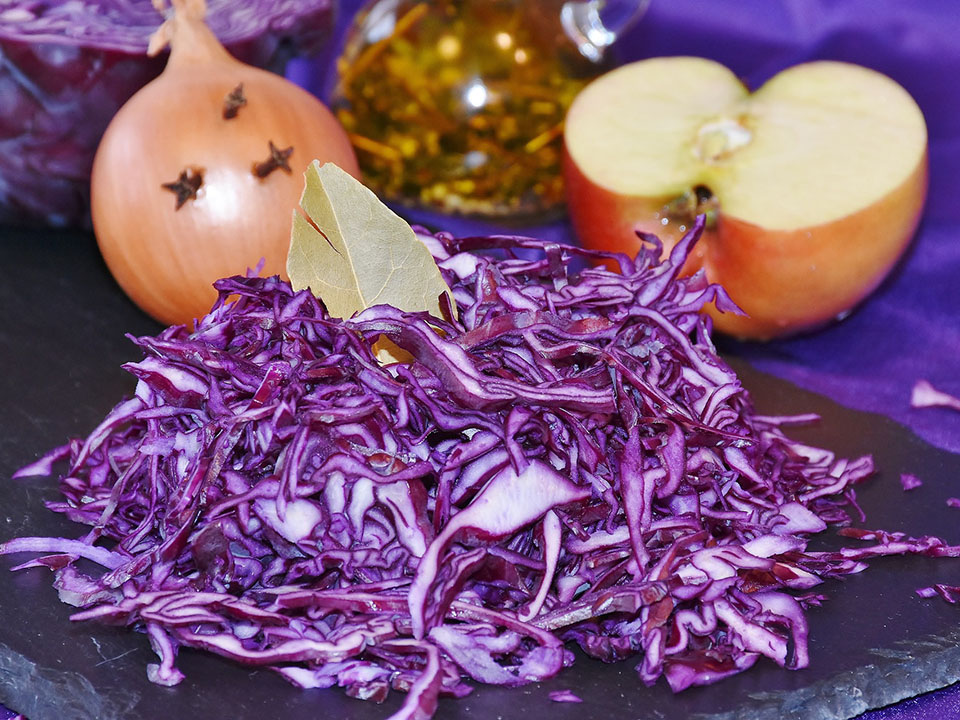 Purple cabbage cut on a table, ready to be cooked