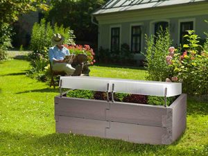 Grey Timber Raised Bed with Covers set up in a garden