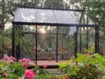 Side view of the Janssens Junior Victorian Glass Greenhouse J-Vic 23 in a garden