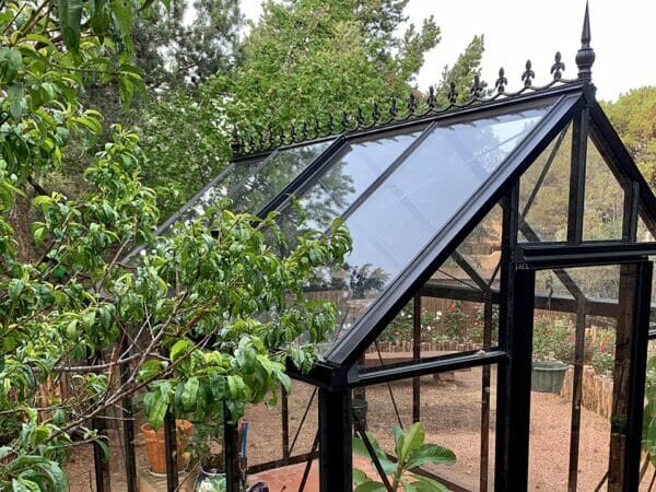 Close-up view of the roof decoration and glass panels of the Black Janssens Junior Victorian Greenhouse J-Vic 23