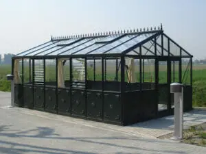 Black frame Retro Victorian VI46 greenhouse on concrete pad, field in background