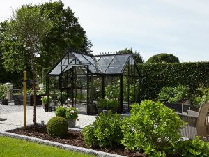 Janssens Junior Victorian Orangerie Glass Greenhouse in a garden