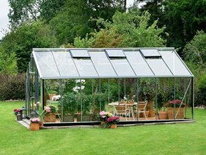 Juliana Gardener Greenhouse 12ft x 19ft - 3mm toughened glass - side view - in a garden