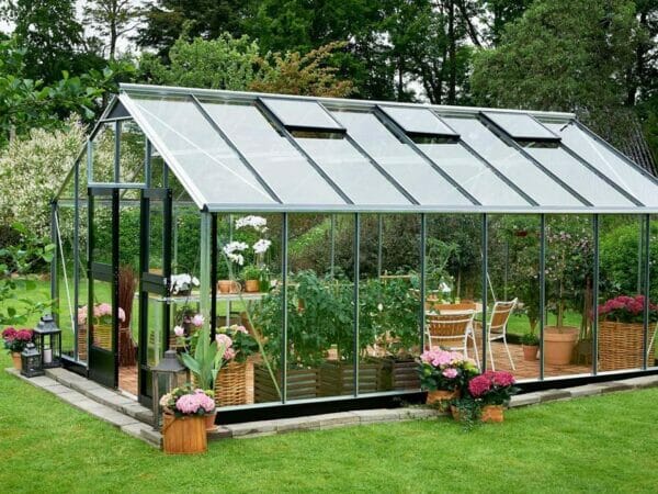 Juliana Gardener Greenhouse 12ft x 19ft - 3mm toughened glass - side view - in a garden