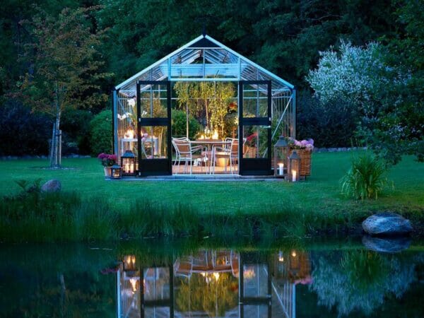 Juliana Gardener Greenhouse 12ft x 19ft - 3mm toughened glass - front view - near a river