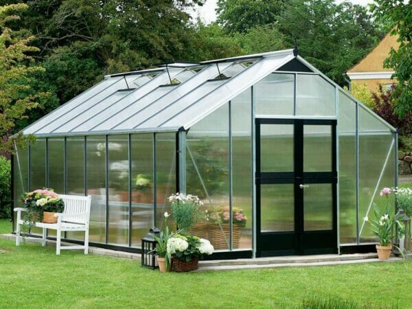 Juliana Gardener Greenhouse 12ft x 19ft - 10mm Polycarbonate - front and side view - in a garden