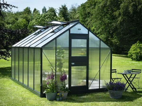 Juliana Junior Greenhouse 9ft x 14ft - Anthracite 6 mm Polycarbonate - closed door - open roof vents front view - in a garden