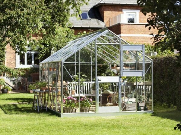 Juliana Junior Greenhouse 9ft x 14ft - Aluminum 3 mm Horticultural Glass - open door - in a garden