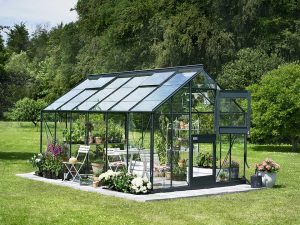 Juliana Junior Greenhouse 9ft x 14ft - Antharcite 3 mm Horticultural Glass - uuper hinged door open - in a garden