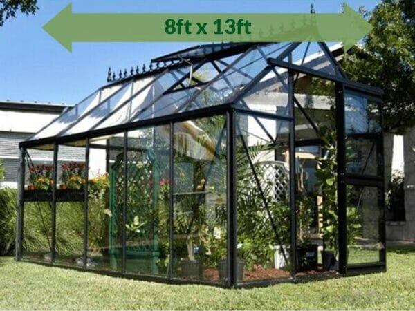 Janssens Junior Victorian J-VIC 24 Greenhouse 8ft x 13ft - full view - in a garden - a green arrow on top showing dimensions
