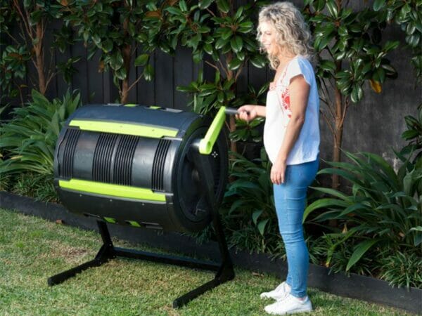 Woman on the right side spinning the MAZE Composter by using the handle