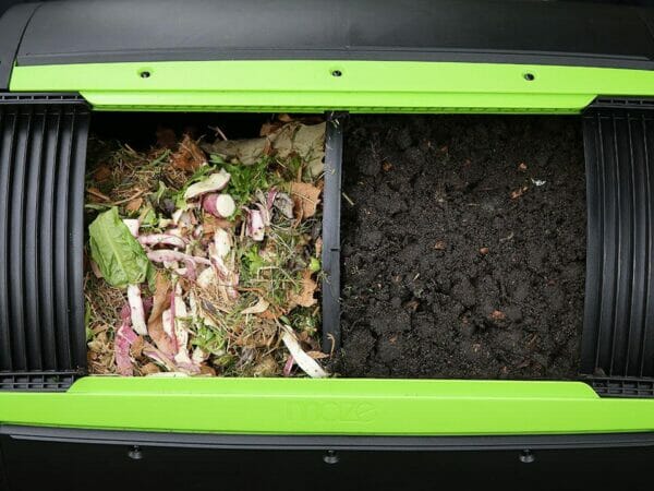 Kitchen scraps in one side and mature compost on the other side of the MAZE Two-Stage Compost Tumbler