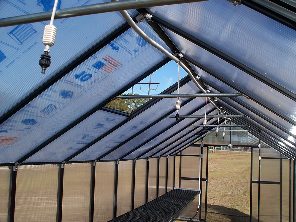 Programmable watering system (installed on the peak) inside a Monticello Premium greenhouse