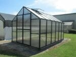 MONT 8x16 Polycarbonate greenhouse on level surface, outdoor setting
