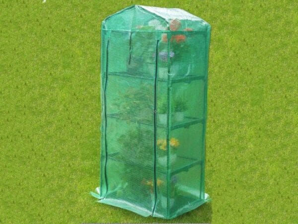 Genesis Portable Rolling Greenhouse with closed opaque cover and plants inside placed on a garden