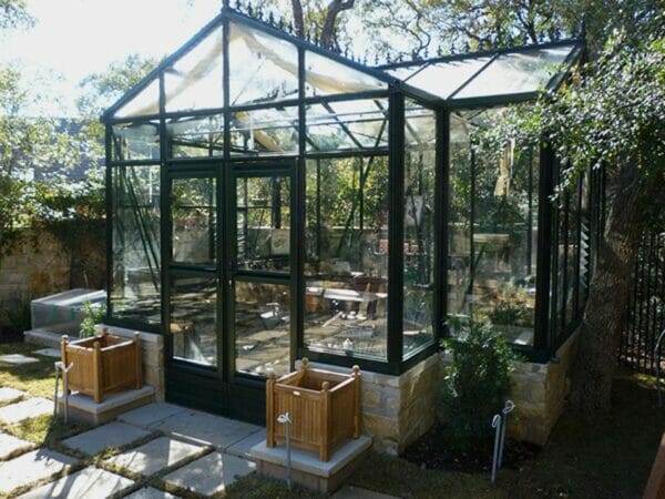 Front view of the Janssens T-Shaped Royal Victorian Orangerie 10ft x 16ft set up in a garden