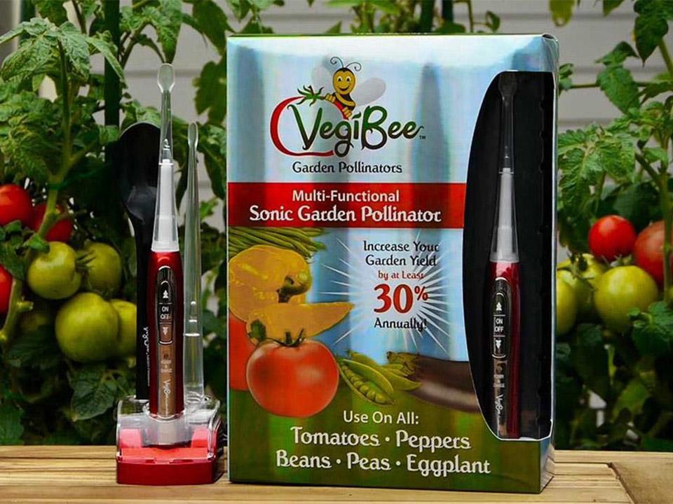 RSI Vegi-Bee mechanical pollinator system with the box on the right side and tomato plants on the background