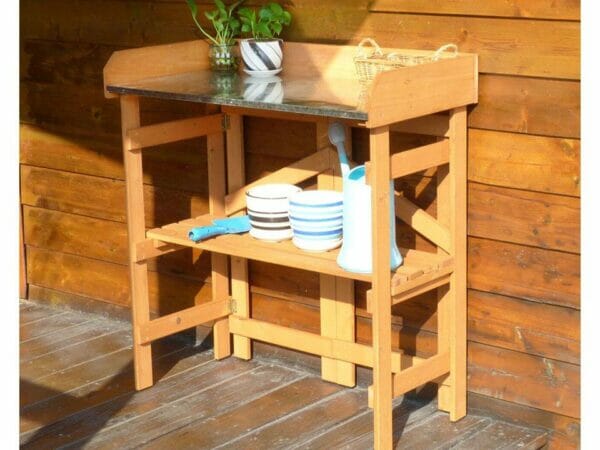 Folding Potting Bench with Zinc Surface by the wall with plants and tools