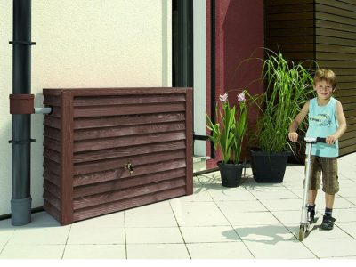 Slatted Rain Barrel on the left side and a boy riding a skooter on the right side