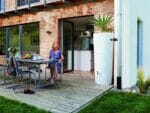 A woman sitting on a table looking at the Wave Barrel & Planter