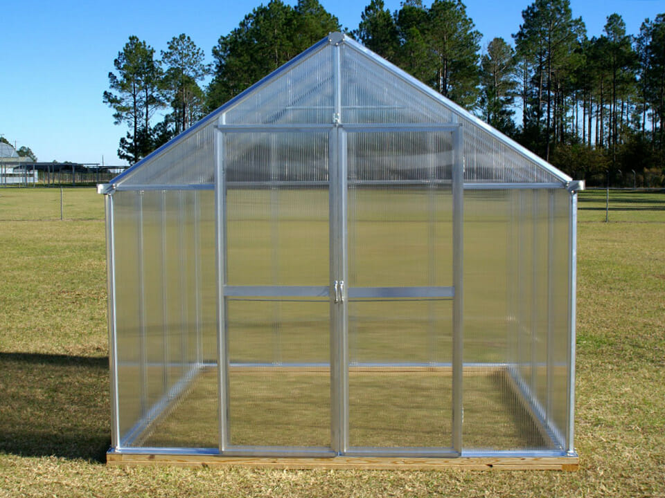 Wooden footing under a hobby greenhouse on a lawn