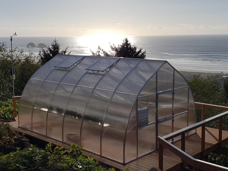 Gothic arch greenhouse (Riga XL 6) on a wooden platform