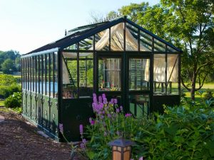 Retro Victorian VI36 greenhouse, green frame with decorative panels, double doors installed at end, shade curtains on interior