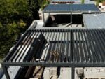 Aerial view of rooftop Selt System Sunbreaker 400 Pergola installation, black, slats open