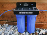 Installed GrowMax Water Eco Grow 240 in front of wooden planter