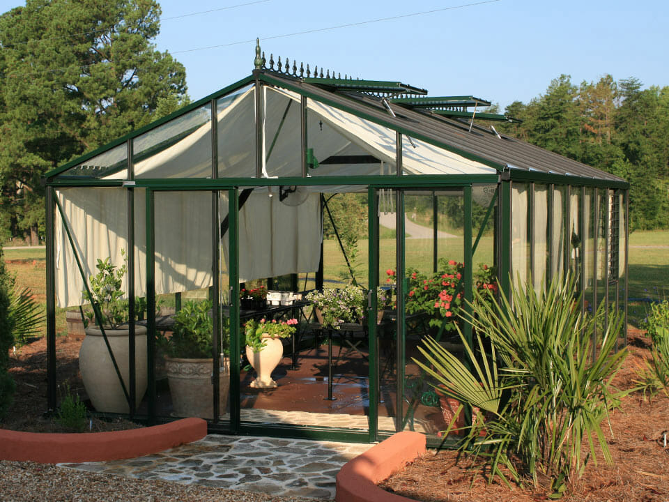 Glass greenhouse with internal shade curtains