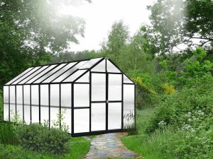 Exterior front and side view MONT Growers 8x16, black frame, polycarbonate panels, door closed, garden setting with stone path leading to door