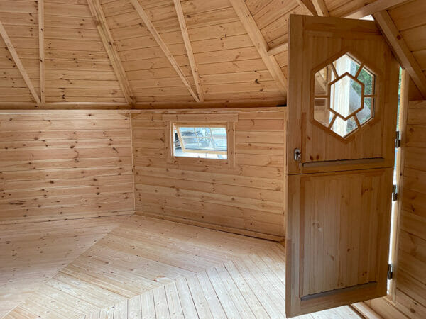The interior of the wooden Pyramid Grill Cabin with an open door