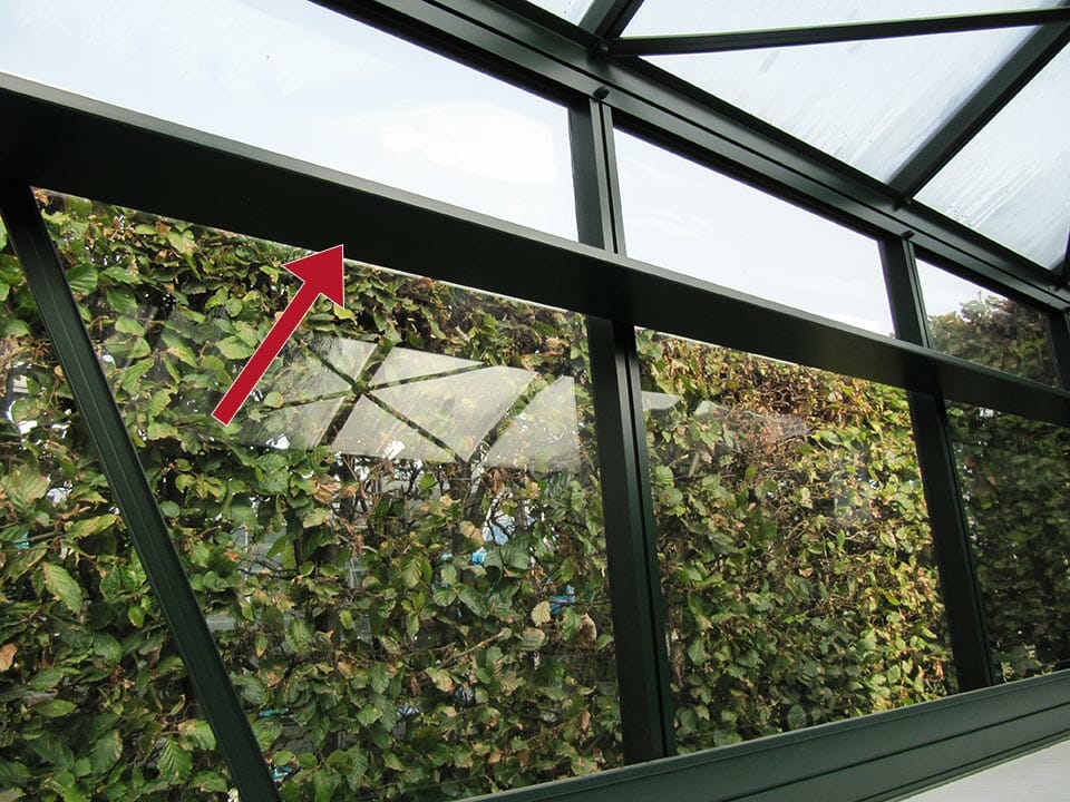 Janssens Top Shelf installed in a glass greenhouse, photo taken from the bottom