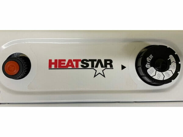 Battery-operated ignition starter and thermostat control dial of the RSI Radiant Propane Gas Greenhouse Heater, Heatstar logo in between two dials