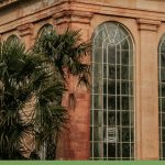 Brick and stone conservatory greenhouse with text: Simple or Stately How Do You Pick the Right Greenhouse?