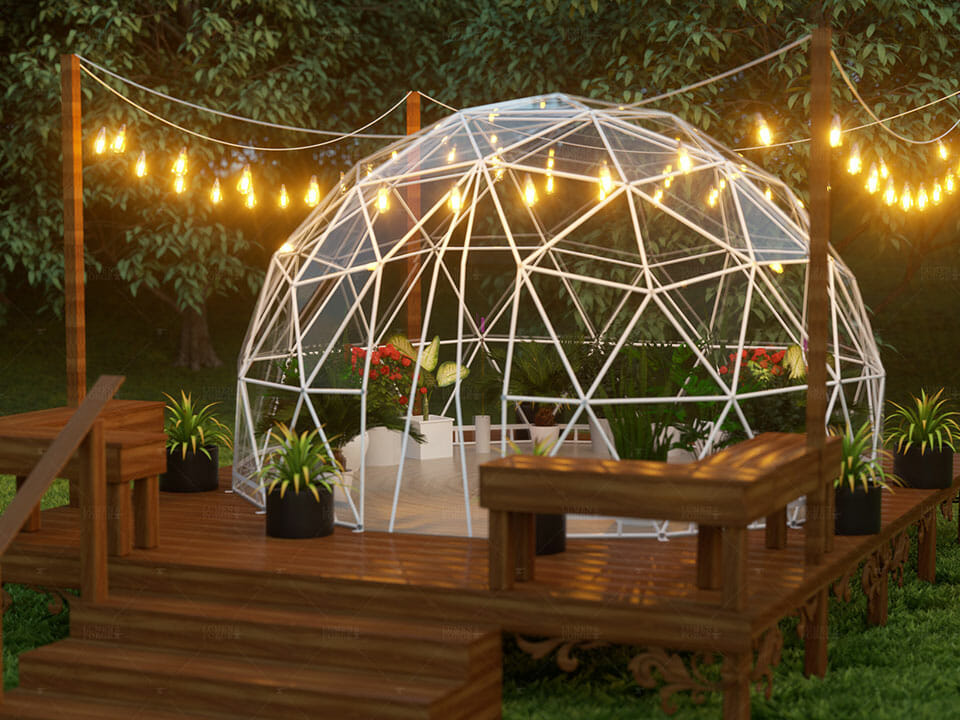 Geodesic Dome greenhouse with white steel frame and clear vinyl cover, night scene, on deck with string lights for illumination