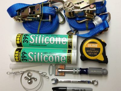 The RIGA XL facilitation kit including two J-hook ratchet straps, 2 tubes Boss399 silicone, open and closed socket wrenches, permanent marker, measuring tape and window restraint cable