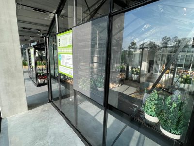 Black framed fly screen cover on a louver vent of a Janssens Greenhouse