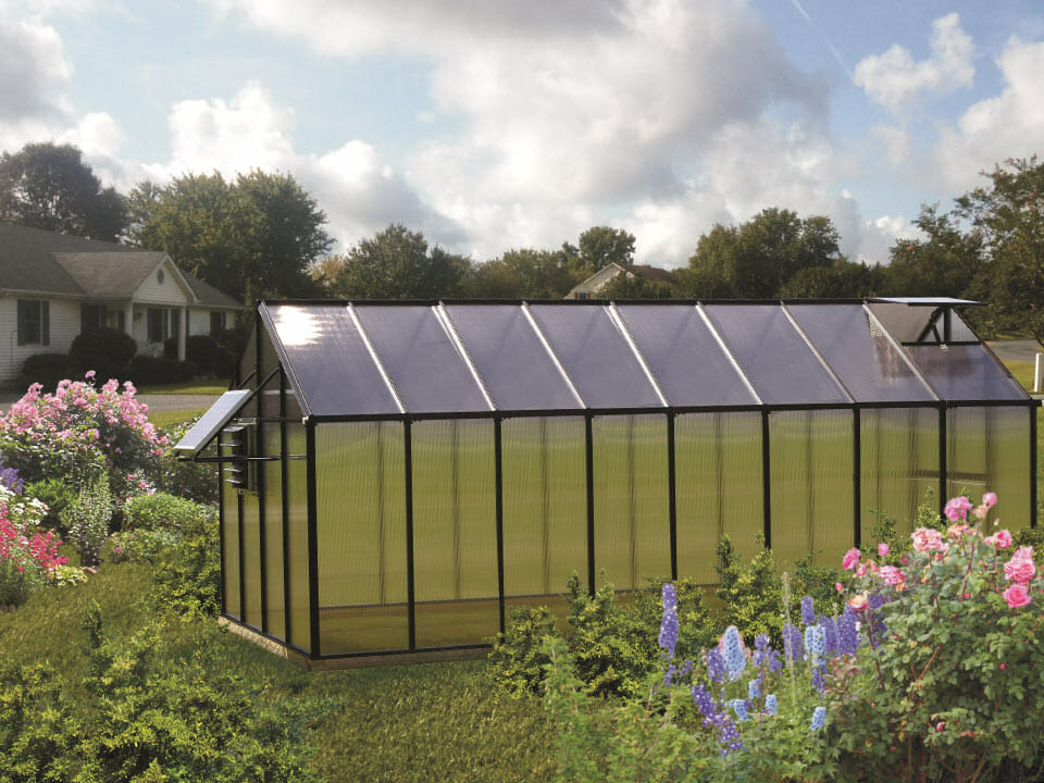 MONT 8x16 Greenhouse - Moheat Edition with a solar fan and tinted roof panels in a garden setting