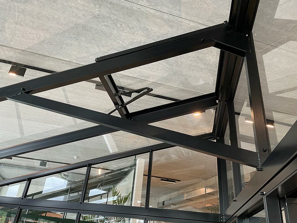 Inside detail of the Janssens Modern Greenhouse with a roof vent and a support beam